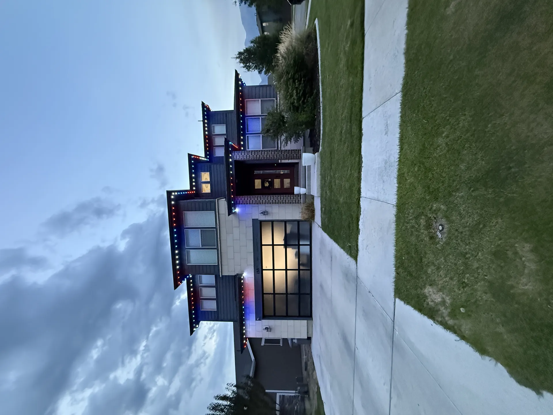 Home exterior with landscape lights along front yard